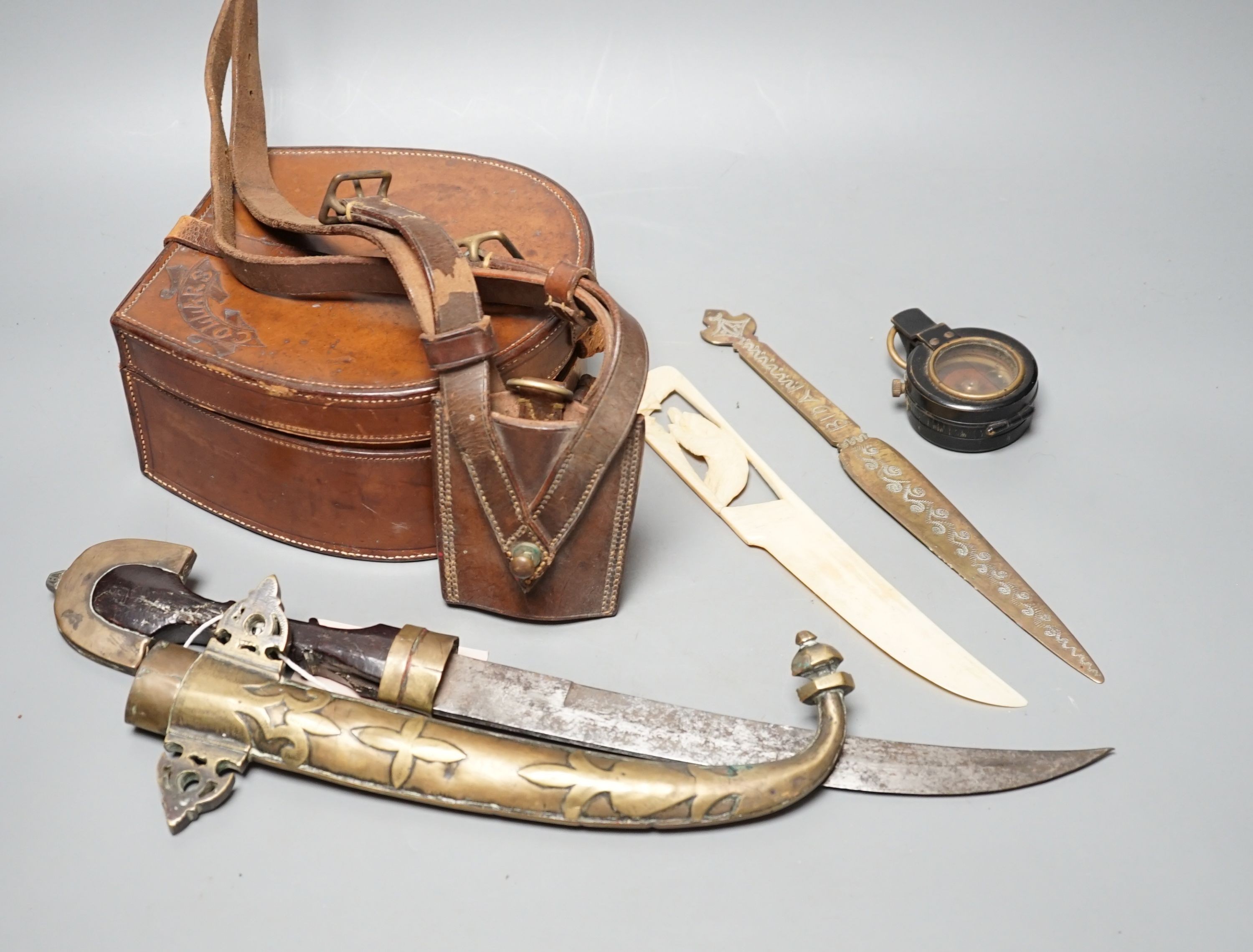An Eastern dagger, in sheath, leather collars box, cased early 20th century Dollond compass and three others
